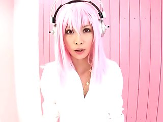 A pink haired Japanese babe in a bikini gets jizzed on